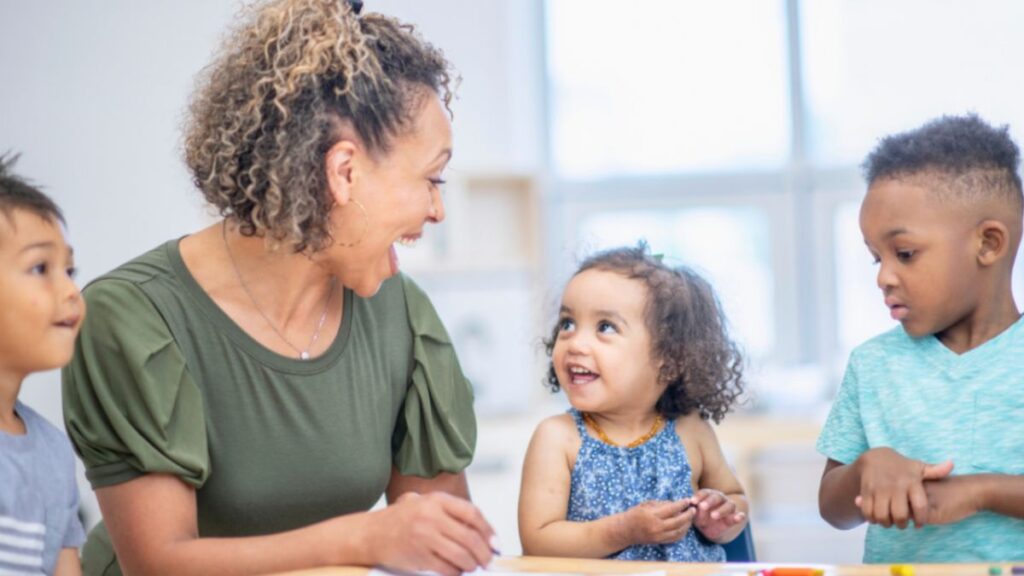 A woman depicting meaningful work as a teacher to little children.